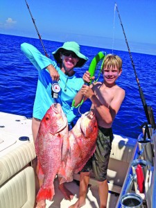 Heather Gardner and Andrew, age 11 hold up a pair of snapper destined  for the dinner plate