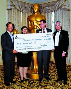 Outgoing Guild President Alberta Hipps presented a $40,000 check to Jacksonville Symphony Board chairman Richard Pierpont, left, and president David Pierson, right, far right, Peter Wright, principle clarinetist