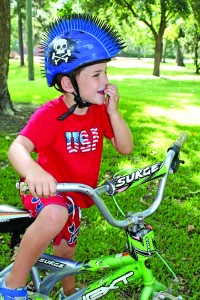 Will Larkin, age 5, sports a trendy, mohawk-style bicycle helmet in bright blue – the perfect way to mix safety and fun on Independence Day