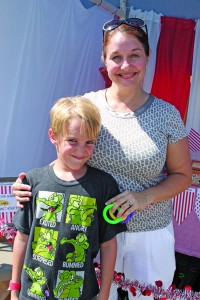 Austin, 7, with mom Kim Shepard manning the ring toss booth sponsored by the Second Grade Class