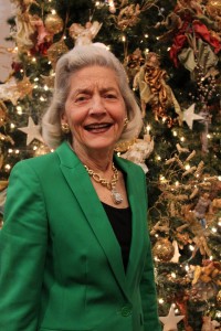 Ortega resident and philanthropist Betsy Lovett poses in front of the mammoth Christmas tree that she has generously supplied to the Gingerbread Extravaganza each year.