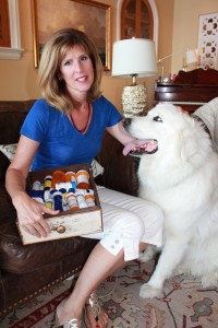 Mary Jaycox holds a drawer full of medications but says that Moose, her Great Pyrenees, is the “best medication there is.”