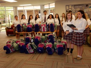 Led by Ally Schneider and Lily El Hassan, members of the Bishop Kenny High School Interact Club donate 25 backpacks to victims of human trafficking on the First Coast.