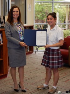 Annmarie Kent-Willette of the Mayor’s office and Lauren Toledo of Bishop Kenny hold a letter from the Mayor commending the school’s Interact Club for its contribution to victims of human trafficking.