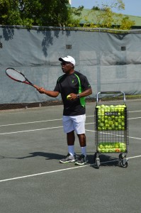 Coach Harrell Thomas gives a private lesson on the new clay court.