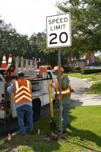 Public Works traffic engineers Danny Williams and Gary LaFrance installed 20-mph speed limit signs on River Road July 28.
