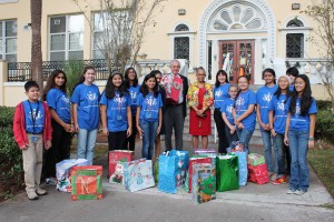 Jack Milne, Dr. Sylvia Johnson and Jaime Sanborn (center), surrounded by Bolles Library Media Ambassadors who brought books to students at West Riverside Elementary School.