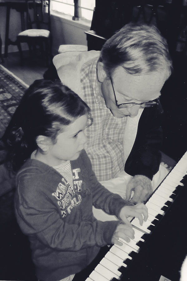 Bill Joos teaches a granddaughter to play the piano