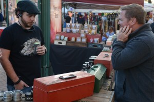 Corey Crawford of the 5 Points Candle Company and Mancanics, a men’s grooming product line, speaks to a passerby who inquired about his beard grooming products.