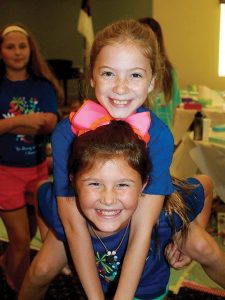 “I liked how I could talk to my counselors and my small group about God, and not feel self-conscious,” said Chase Duggan, getting a piggyback ride from Ginny Kurlas.