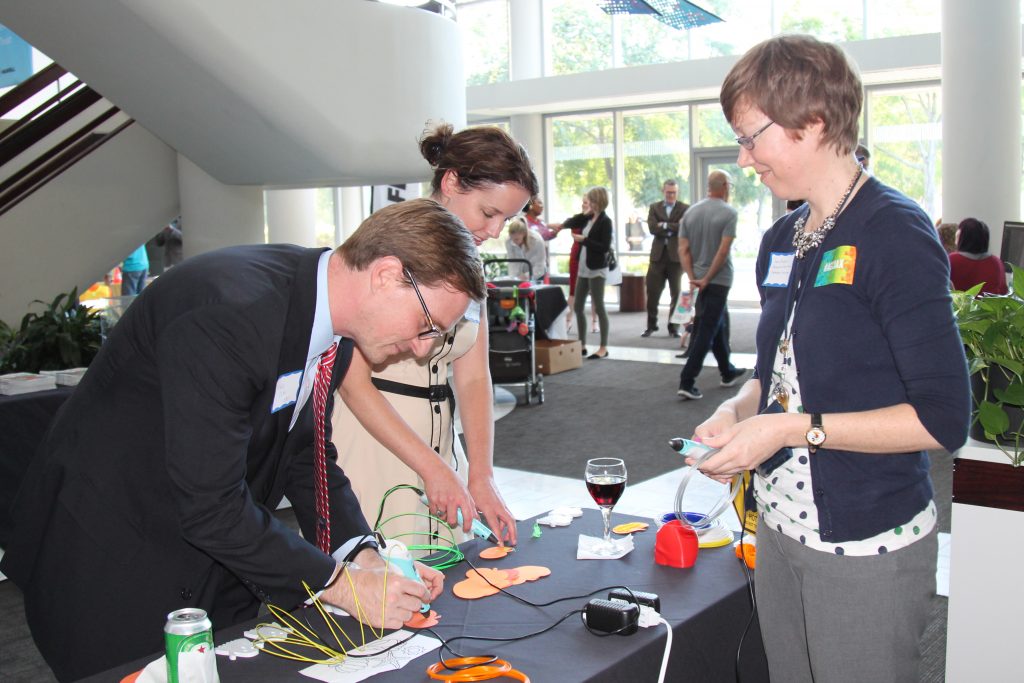 Trey Csar and Beth Harralson try out 3D pens under the watchful eye of Sara Radovic, Jacksonville Public Library Makespace Coordinator.