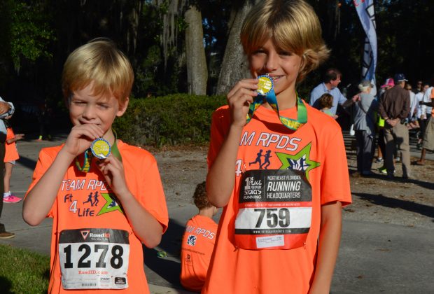 Sam Barksdale joins his friend Harrison Cavendish after the fun run during the Ryan’s Run event at Ortega United Methodist Church Nov. 5. Cavendish won the mile-long event with a time of 6:37.