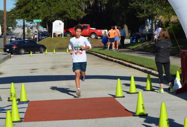 Bolles student Kevin Ding finishes the 5K race during Ryan’s Run Nov. 5.