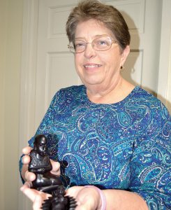 Cindy Graves holds Baby Jesus and Mary, carved pieces from a nativity scene made in Kenya