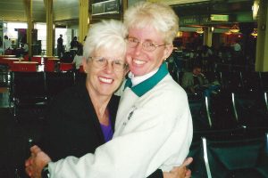 Rosalee Connor hugs sister Natalie Bryan in an airport, 2000