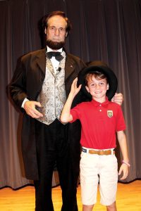 St. Mark’s Episcopal Day School fifth-grade student Jack Potter tries on Abraham Lincoln’s top hat.