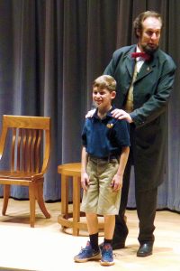 Abraham Lincoln presenter Dennis Boggs enlists Bolles student Lucas Harris in a demonstration of one of Lincoln’s boyhood pranks.