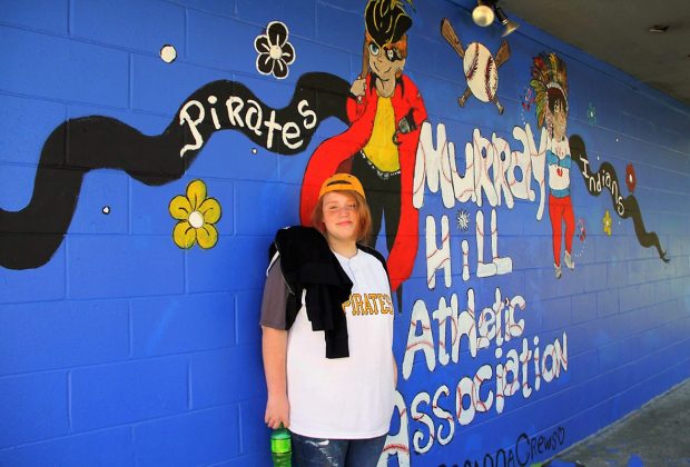 Mural artist Breanna Crews added some creativity to the side of the MHAA concession stand to mark opening day of the baseball season. (Photo by Mike Bonts)