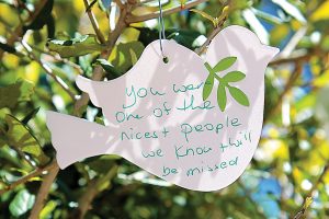 One of the many paper doves attached to branches of a live oak planted in Boone Park South in memory of Harold McKeon.