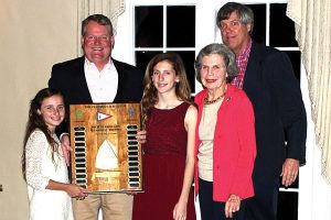 Tim Monahan with his winning daughters, Mary Katherine, left, and Bridget, as they receive the Burroughs Trophy at the 2016 Yachtsman of the Year Award Banquet at Florida Yacht Club. Mary Katherine won for Top Green Fleet Opti Sailor, while Bridget was Top Advanced Fleet Opti sailor for 2016. With the Monahans are Caroline Burroughs and her son, Chandler, who presented the Dick Burroughs Memorial Trophy.