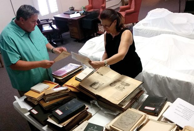 Jeff Tawney and Naomi Sheridan sift through piles of documents for archiving.
