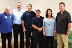 Retired Jacksonville Firefighter John Peavy, Randy Wyse, Jacksonville Association of Firefighters president with Firefighters Kevin Foley and Jeshua Kavanaugh, Ronald McDonald House Executive Director Diane Boyle, and Anthony Douglas, firefighter and owner of Production Design Group