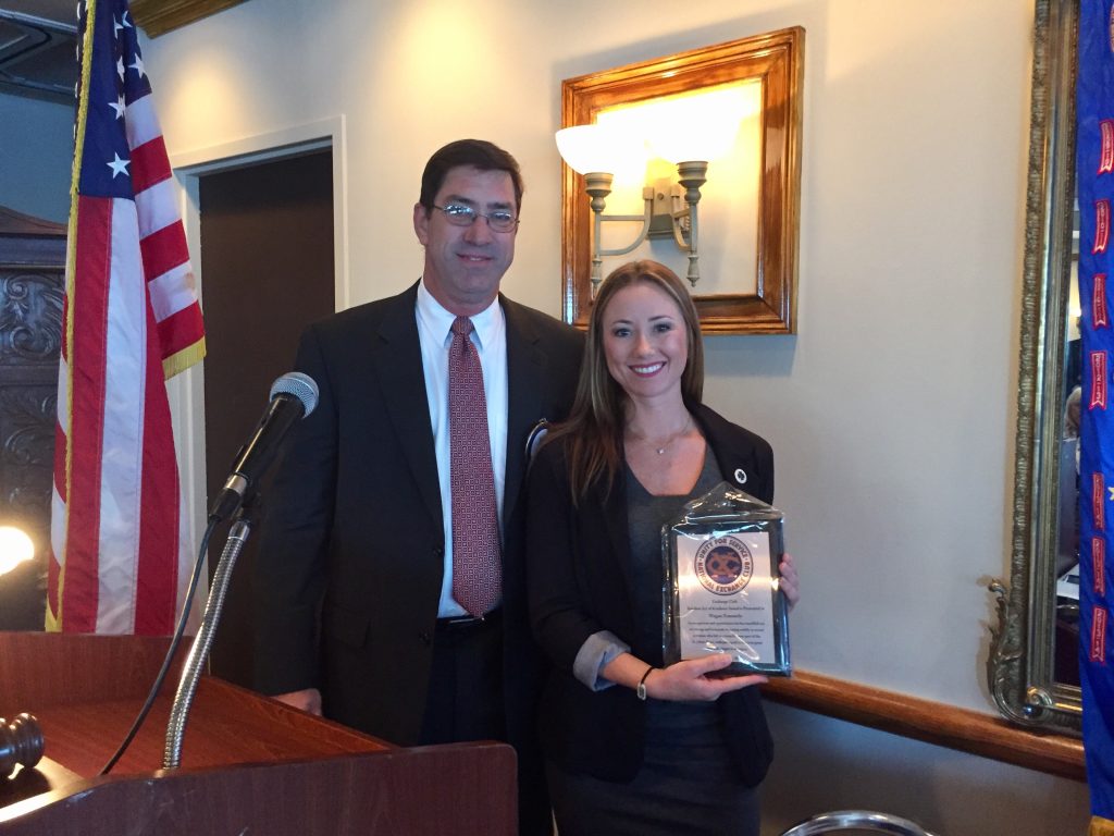 President George Mann, left, and The Exchange Club of Jacksonville honored Megan Zimmerly with its Random Act of Kindness Award on Oct. 26, in recognition of her exceptional display of community service for her efforts in rescuing a woman who had jumped into the St. Johns River. Community service and Americanism are at the cornerstone of the organization's programs of service.