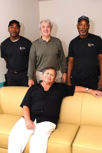 Willie Tell of OE&S helped Mark Manship of MM Products, along with Antony Wetherill of OE&S, to deliver the couch to Israel Lopez Serrano.