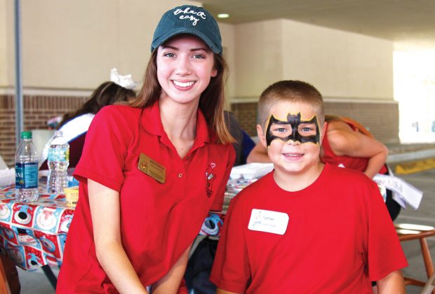 Face-painter Britnee Luke with Nathan Brown, sporting a Batman mask