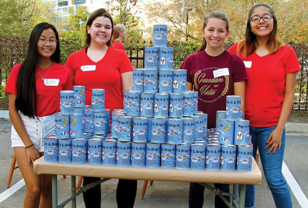 Volunteers from Orange Park High School – McKasie Le, Abby Ferry, Alayna Puls and Alexis Gallardo – affixed labels to “Pop It and Drop It” cans.