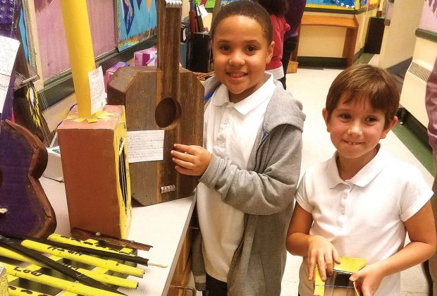 Rashsmar Stout and Zoe Gibson, fourth-grade students, display their projects which show different types of energy.