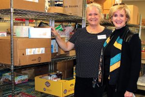 Suzanne Zimmerman, JFCS financial assistance specialist and food pantry manager, with Marsha Pollock, president of River Garden Hebrew Home
