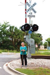 Lilla Ross at the train crossing on River Oaks Road near her home.