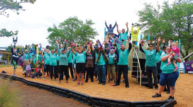 Despite wind and rain, volunteers build playground at Winston Family YMCA
