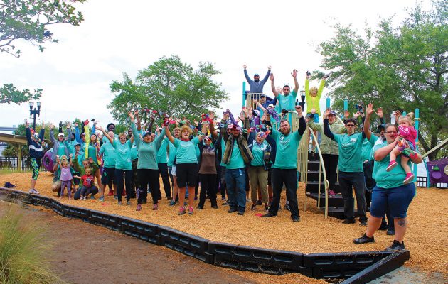 Despite wind and rain, volunteers build playground at Winston Family YMCA