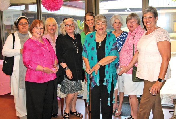 Bosom Buddies friends and supporters gather around Bobbi Hanks, center, at Hanks’ retirement party June 25.