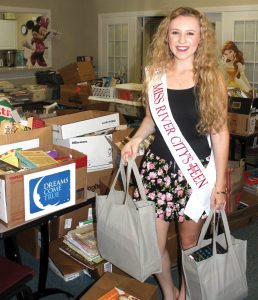 Brookie Brown helping with a book drive at Dreams Come True.
