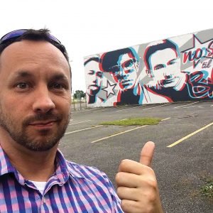 Jason Tetlak points a thumb at his world record-setting 3D mural.