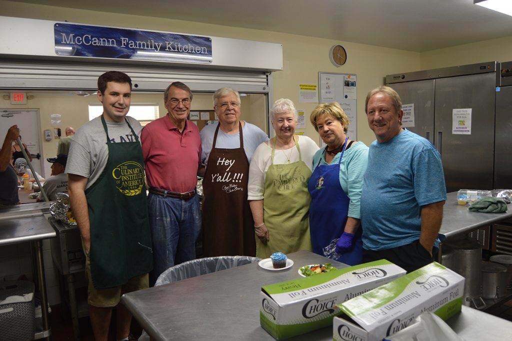 Volunteers Michael Olson, Pat Morrissey, Bill Kornmayer, Rita Kornmayer, Karen Fregeau, and Gary Gregeau from Our Lady Star of the Sea Catholic Church make a hot lunch for the folks at Mission House once a month.