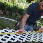 Brian Watkins repairs lattice during a renovation project for a home in Springfield.