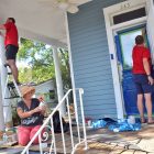 Joshua Wilkerson, Hallie Dufresne and Michael McCall improve the front porch during a renovation project for a home in Springfield.