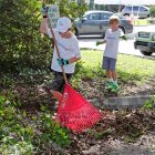Children of Holland & Knight associates help clean up the grounds at the Child Guidance Center on St. Augustine Road.