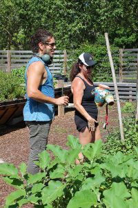 James Siler, Kumar Pictures owner/creative director, discusses shots with community garden coordinator Joan Sullivan.