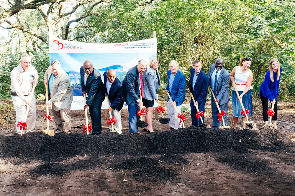 Jim Pellot, Ross McWilliams, Dr. Charles Moreland, Garrett Dennis, Mel Martinez, Shannon Nazworth, Davis McCarty, Greg Matovina, Sam Newby, Michelle Barth and Ann Reinert lift shovels at the Ability Housing groundbreaking Oct. 25 in Hyde Park.