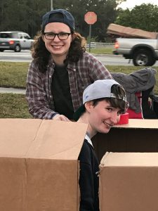 Jame Greene Ancion and Emily Greene learn what it’s  like to sleep with nothing but cardboard to soften  the pavement at Cardboard City 2017.
