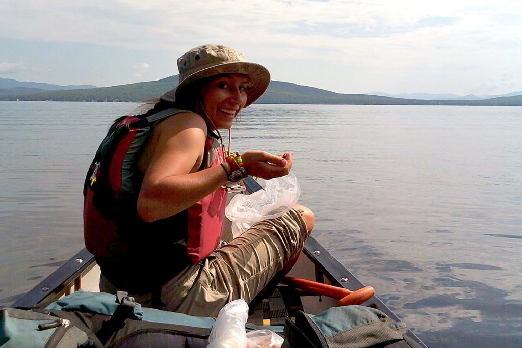 Marley Barton pauses from canoeing to fuel up with gorp.