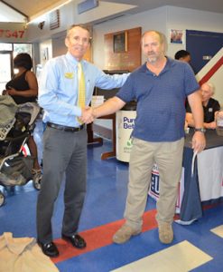 Greater USO Executive Director Mike O’Brien (left) shakes hands with Subway representative Fred Gardner (right) at the Greater Jacksonville USO office during a No Dough Dinner event.
