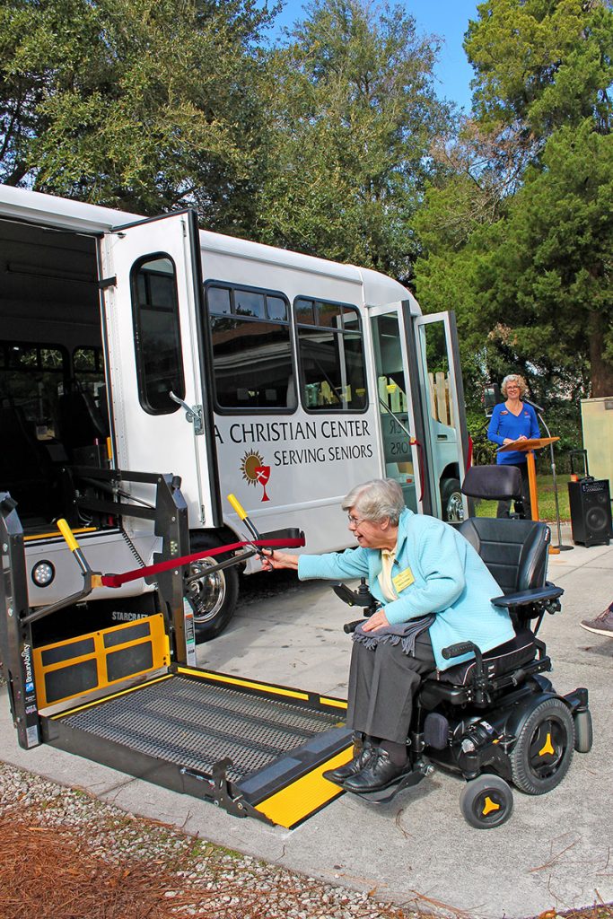 Norma Phillips, resident at the Florida Christian Apartments and a member of the Florida Christian Center’s board of directors, cuts the ribbon to the wheelchair access for the new bus. “We prayed for it, we worked hard for it,” said Phillips.