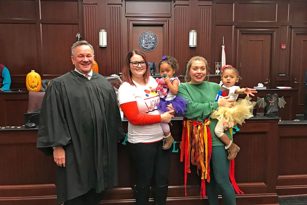 Adoption day “we were a PB & J sandwich,” Jessica said. Included in the photo are Judge David Gooding of the Duval County Family/Dependency Court with Jessica Hamm, Delilah and the girls’ godmother, Gennara Fitzroy, with Caroline.