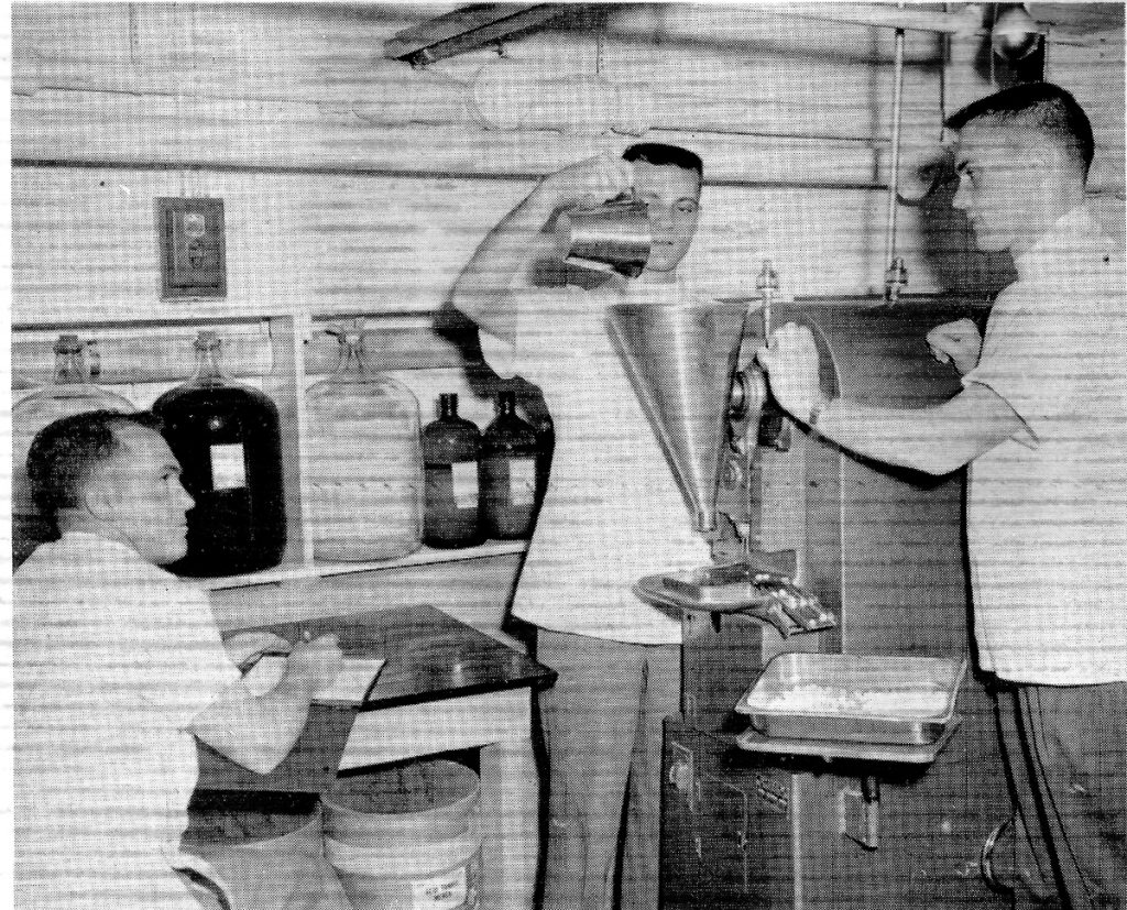 Jim Harp, middle, assists in compressing aspirin tablets at the University of Georgia pharmacy school in 1956.